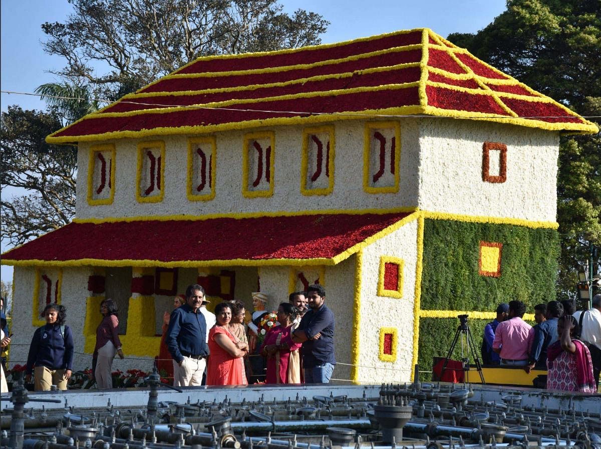 The traditional 'Ainmane' house made out of flowers, is the main attraction in the fruit and flower show in Raja Seat, Madikeri.