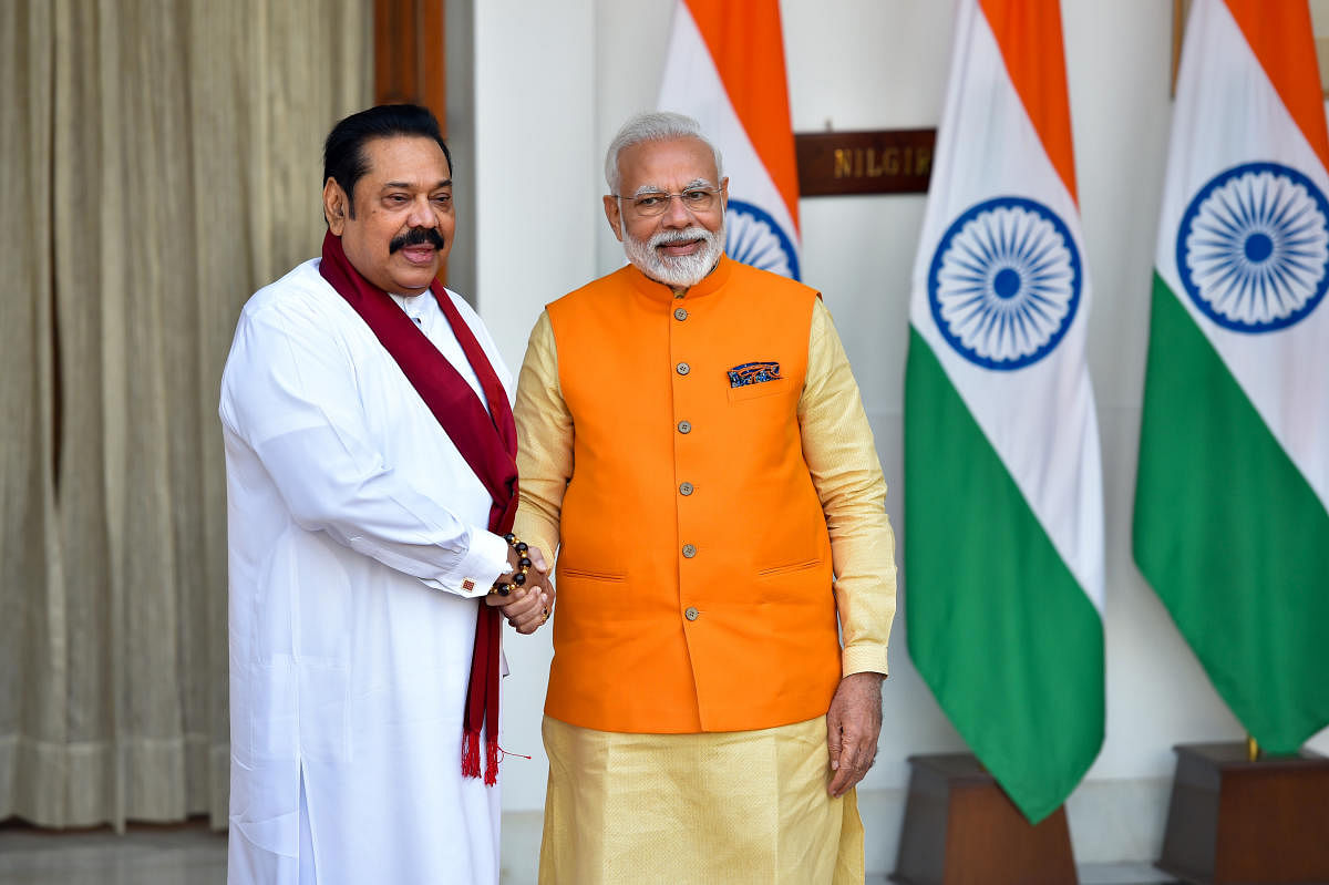 Prime Minister Narendra Modi (R) shakes hands with Sri Lankan Prime Minister Mahinda Rajapaksa (PTI Photo)
