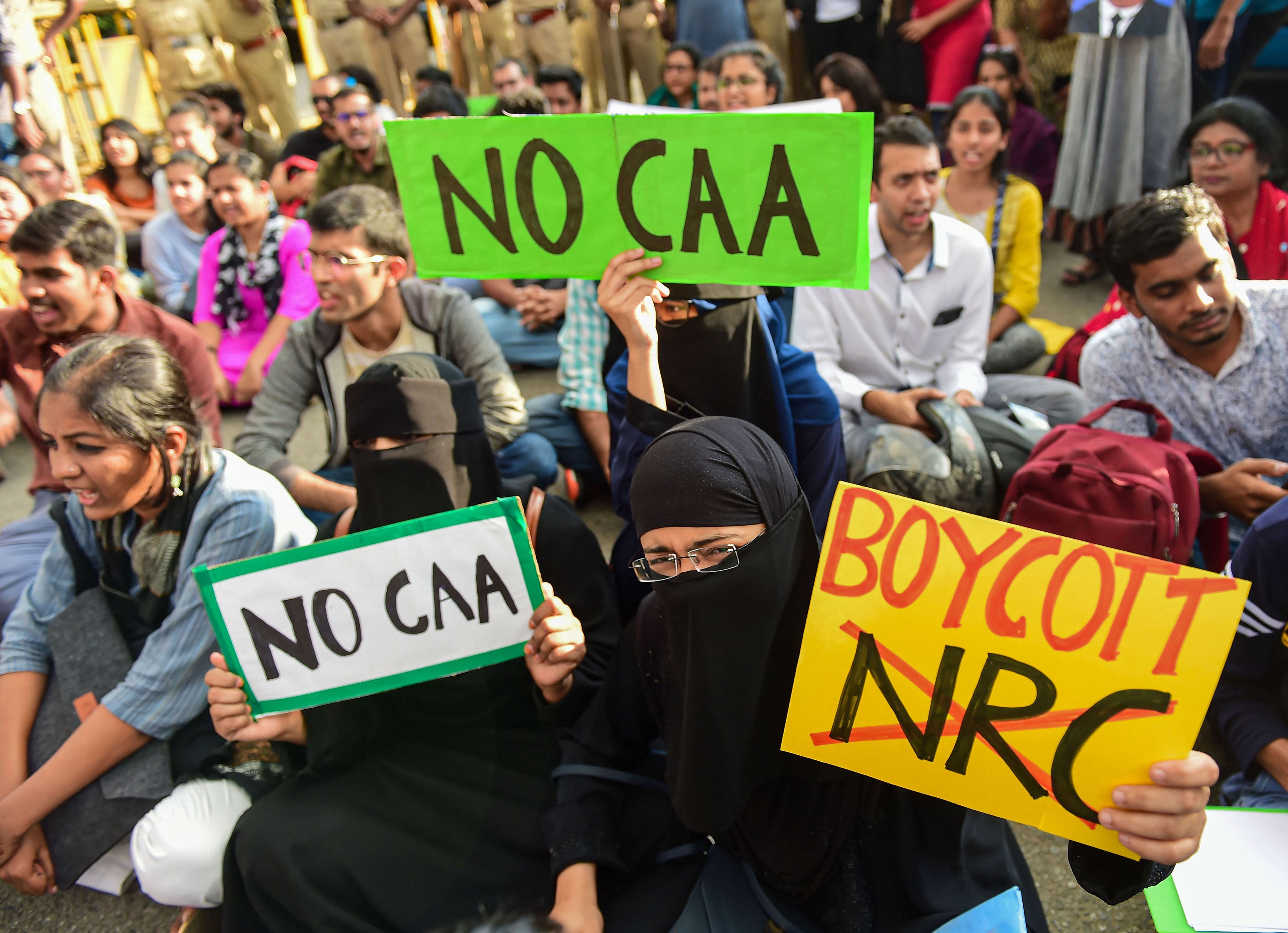 Protestors hold placards and raise slogans protesting against the amended Citizenship Act. (PTI Photo)