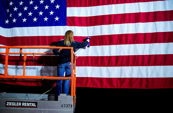 A woman takes the wrinkles from a flag before Pete Buttigieg, Democratic presidential candidate and former South Bend, Indiana mayor attends a watch party on Caucus Day in Des Moines, Iowa, U.S., February 3, 2020. (Reuters Photo)