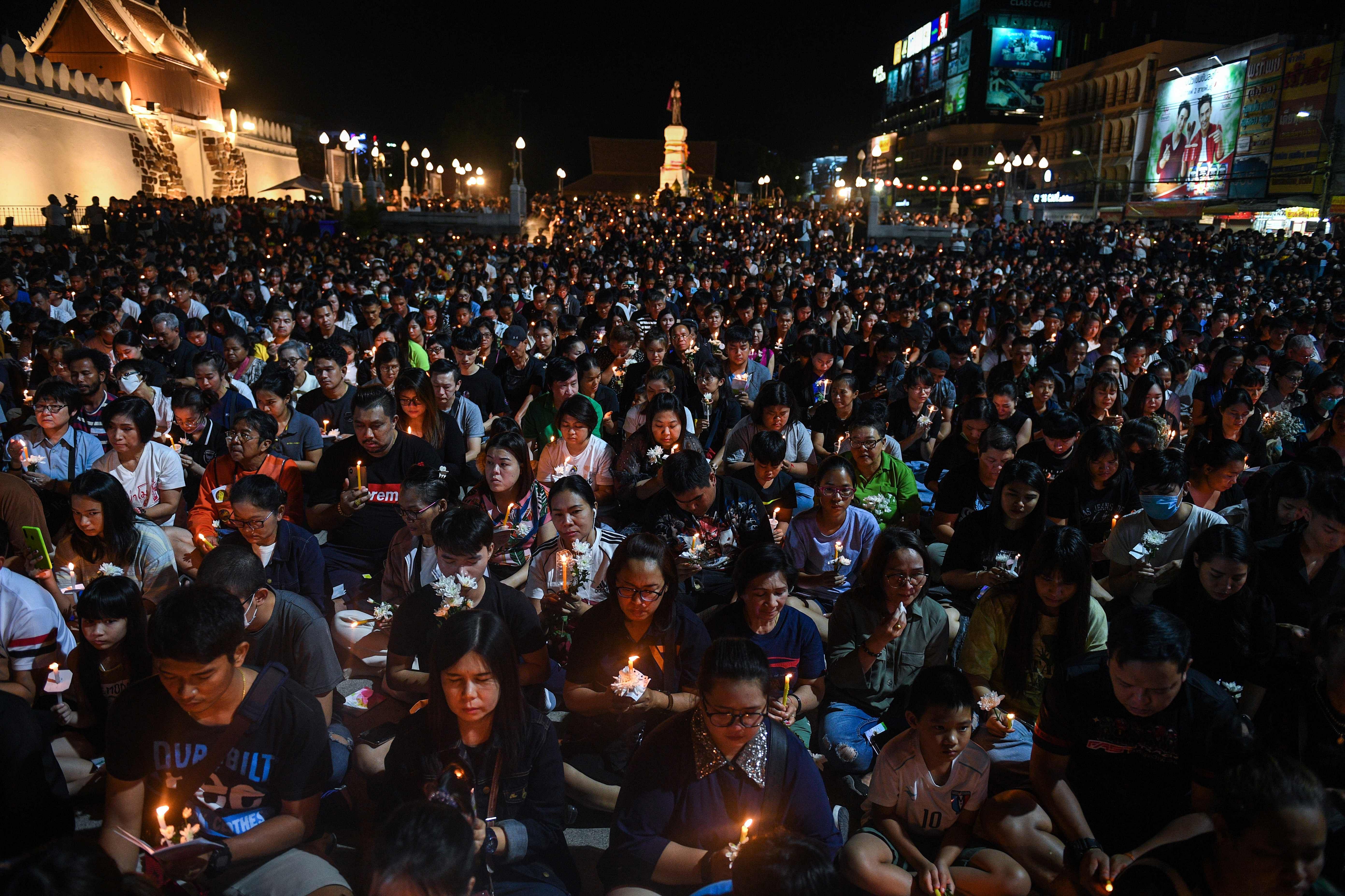 People gather for a candle light vigil following a deadly mass shooting in Nakhon Ratchasima. (AFP Photo)