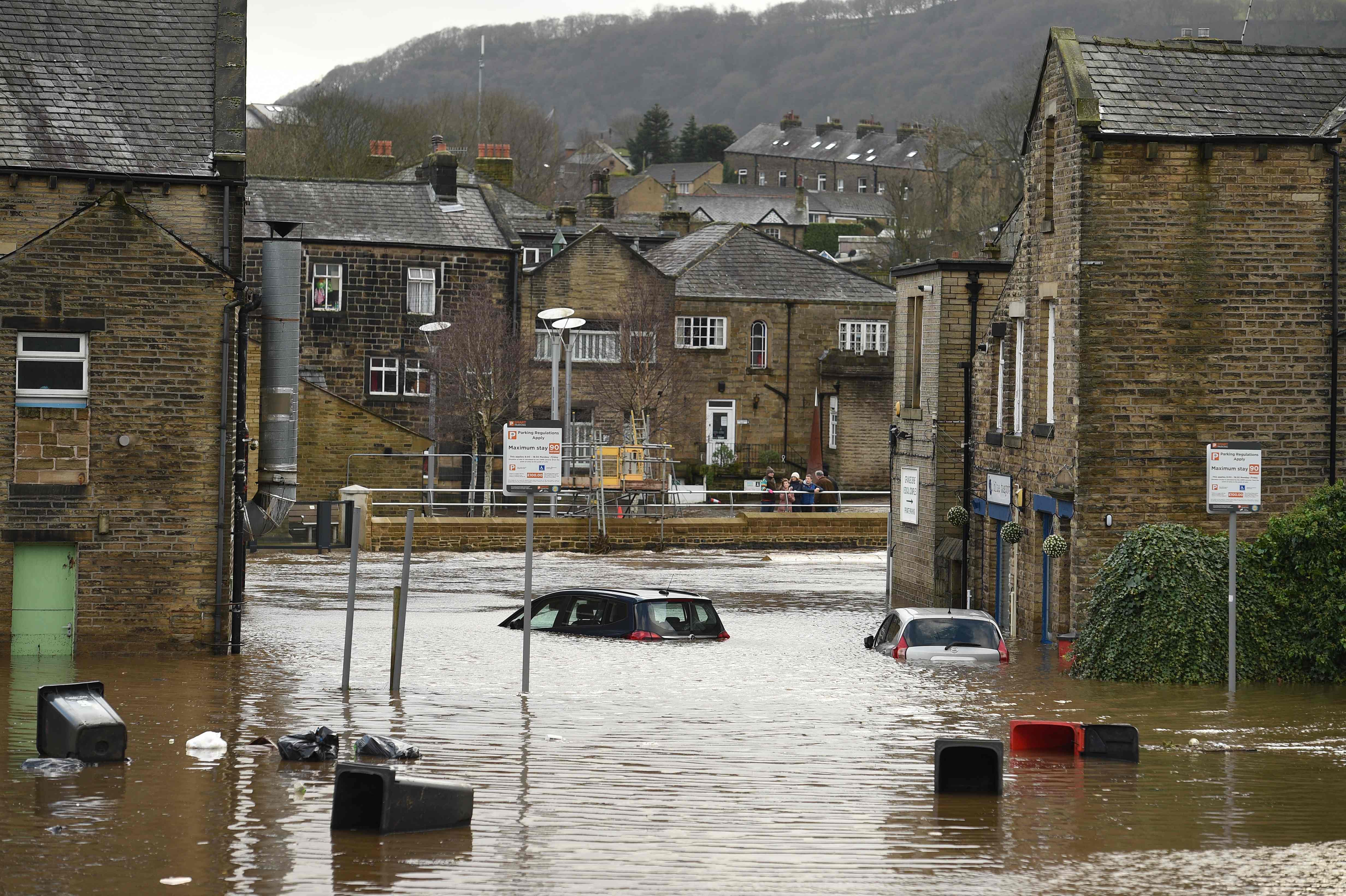 Cars are seen submerged as flood water covers the roads and car parks in Mytholmroyd, northern England, on February 9, 2020, after the River Calder burst its banks as Storm Ciara swept over the country.. (AFP Photo)