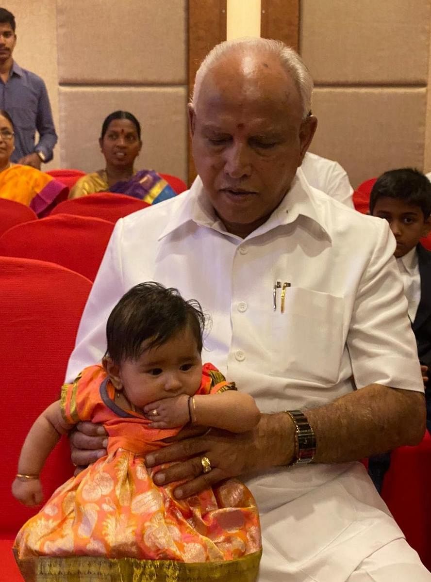 Chief Minister B S Yediyurappa with his great granddaughter Nyra in Hubballi on Sunday.