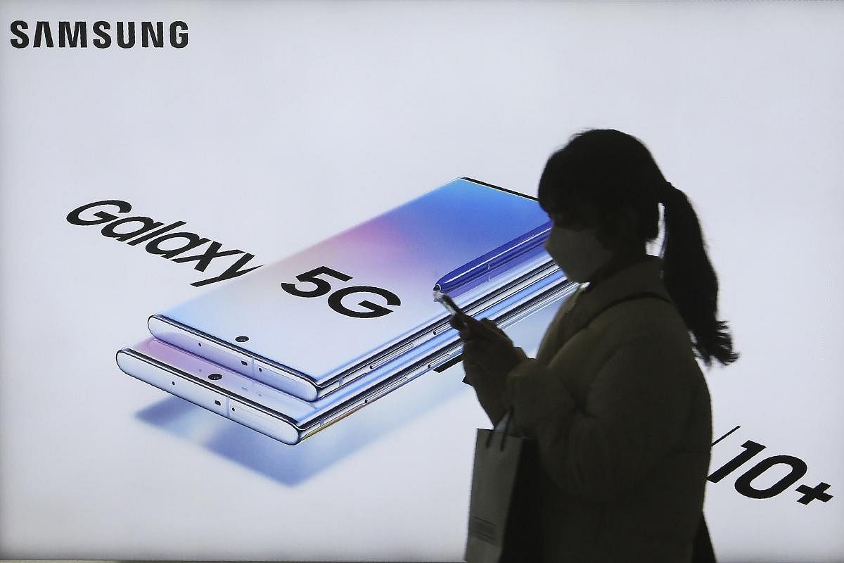 A woman passes by an advertisement of Samsung Electronics' Galaxy 5G Note10+ smartphone at a subway station in Seoul, South Korea (Credit: AP)