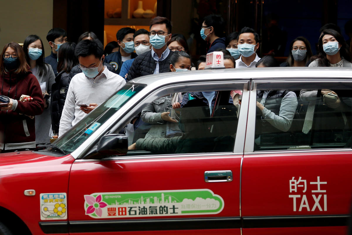 People wear protective masks as they wait to cross the street, following the outbreak of the new coronavirus, in Hong Kong, China February 10, 2020. (Reuters photo)