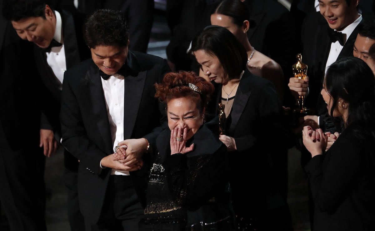 Miky Lee (C), Kwak Sin Ae, and cast and crew react after winning the Oscar for Best Picture for "Parasite" at the 92nd Academy Awards in Hollywood, Los Angeles, California. Reuters