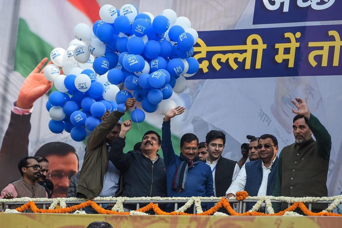 Aam Aadmi Party (AAP) chief Arvind Kejriwal (C) gestures towards his supporters at the party headquarters in New Delhi (AFP Photo)