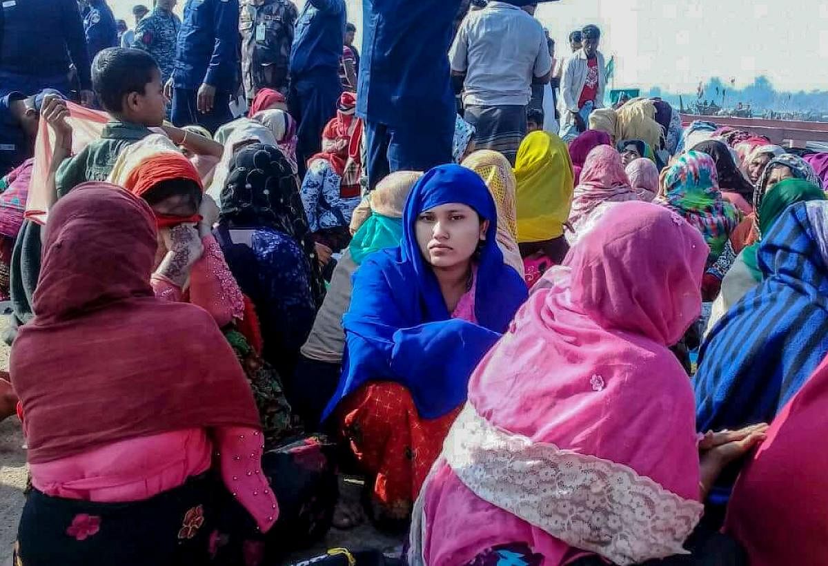 Rohingya refugees wait in an area following a boat capsizing accident, in Teknaf (AFP Photo)