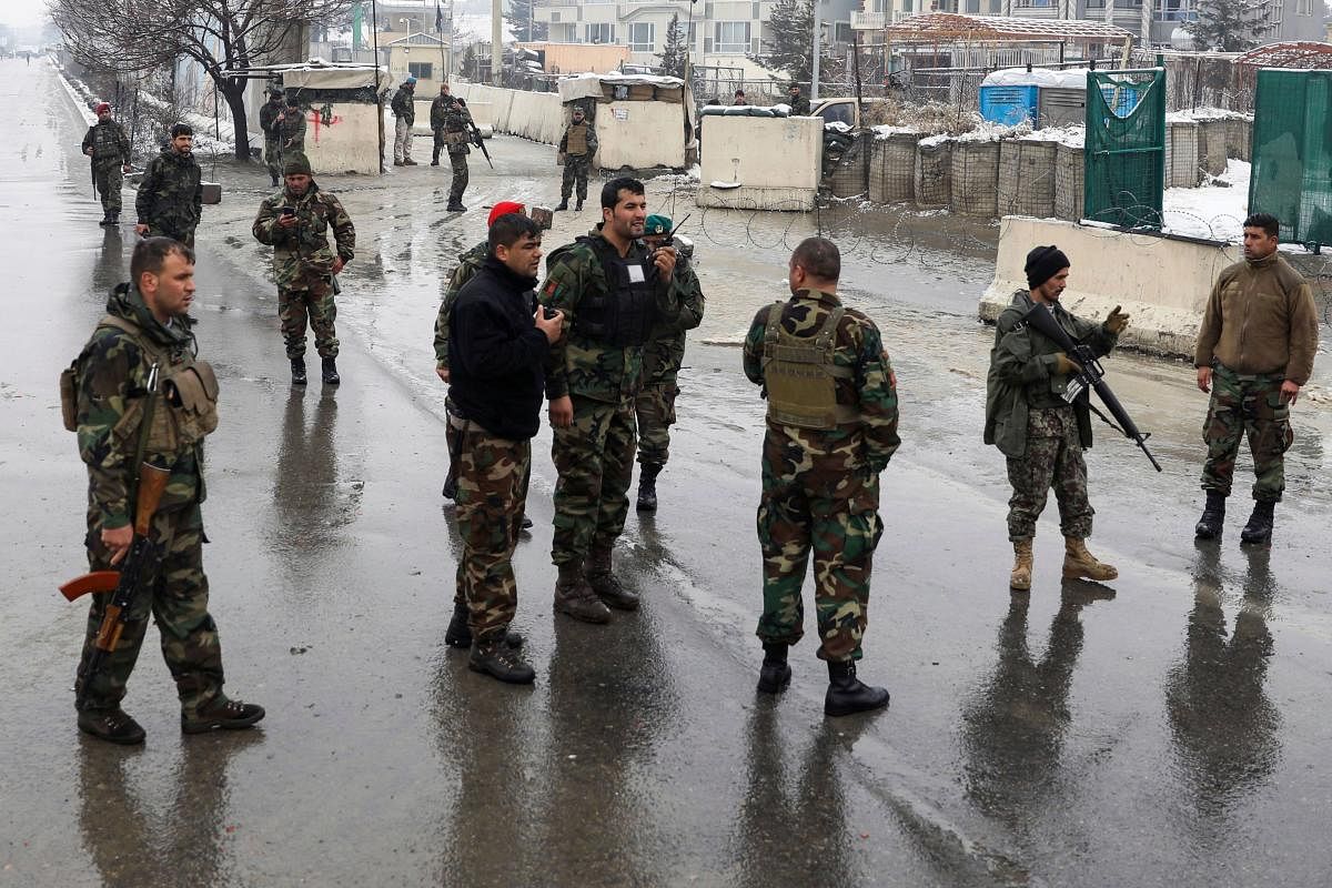 Afghan soliders gather on a road following a suicide attack near the Marshal Fahim Military Academy base in Kabul on February 11, 2020. (AFP Photo)