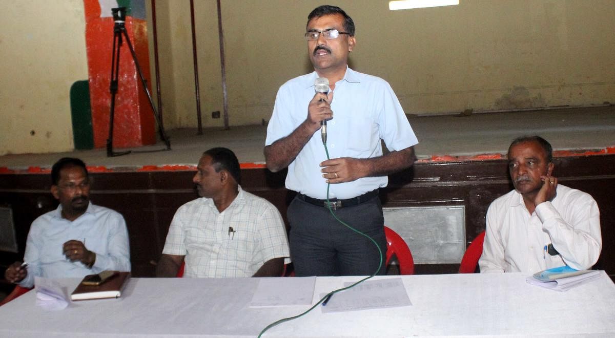 Assistant Commissioner T Javaregowda speaks during a meeting held at Kaveri Kalakshetra in Madikeri on Tuesday.