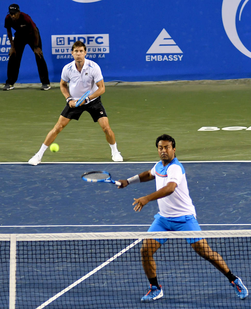 India's Leander Paes and Australia’s Matthew Ebden en route their win against Blaz Rola and Zhizhen Zhang in their Bengaluru Open match at the KSLTA court on Wednesday. DH PHOTO/PUSHKAR V 