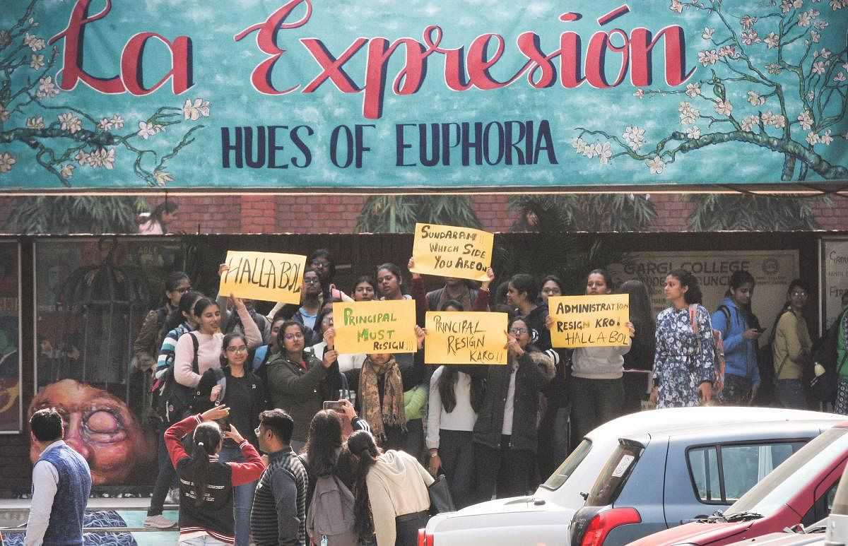 Students hold placards during a protest, against the alleged molestation of students by a group of men who had gatecrashed a cultural festival, at Gargi College (PTI Photo)