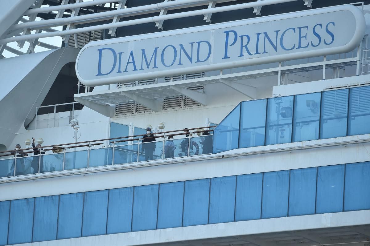 Passengers are seen on the deck of the Diamond Princess cruise ship, with around 3,600 people quarantined onboard due to fears of the new coronavirus (AFP Photo)