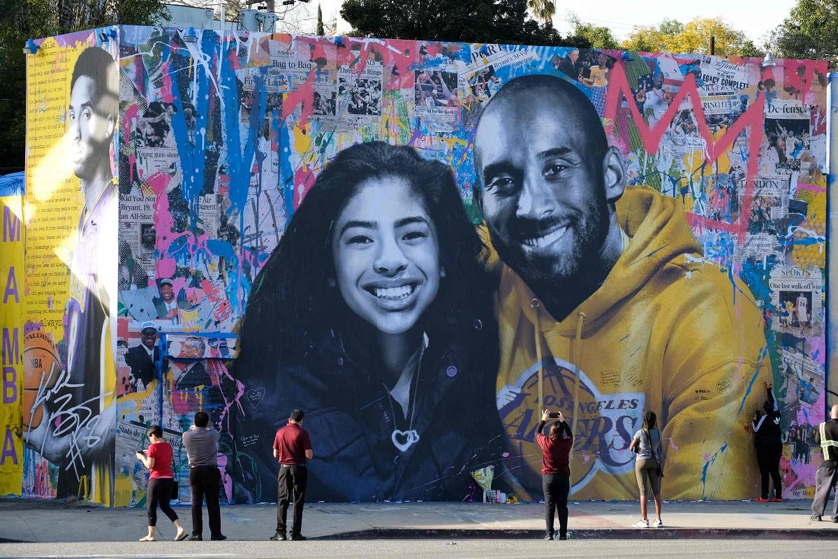  In this file photo taken on January 31, 2020 people take pictures of a mural by French artist Mr. Brainwash of late NBA legend Kobe Bryant and his daughter Gianna in Los Angeles. AFP File Photo