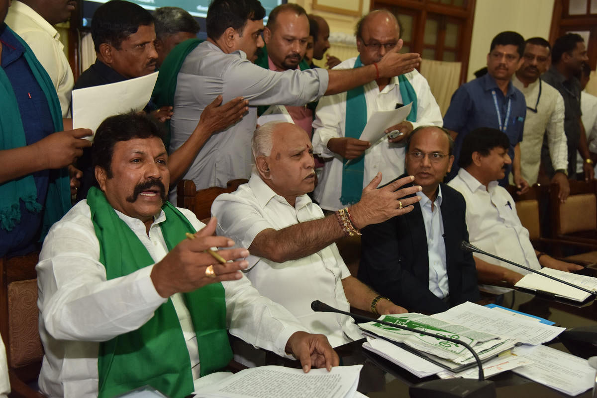 Chief Minister B S Yediyurappa and Agriculture Minister B C Patil gesture during a meeting with farmers at the Vidhana Soudha in Bengaluru on Thursday. dh photo