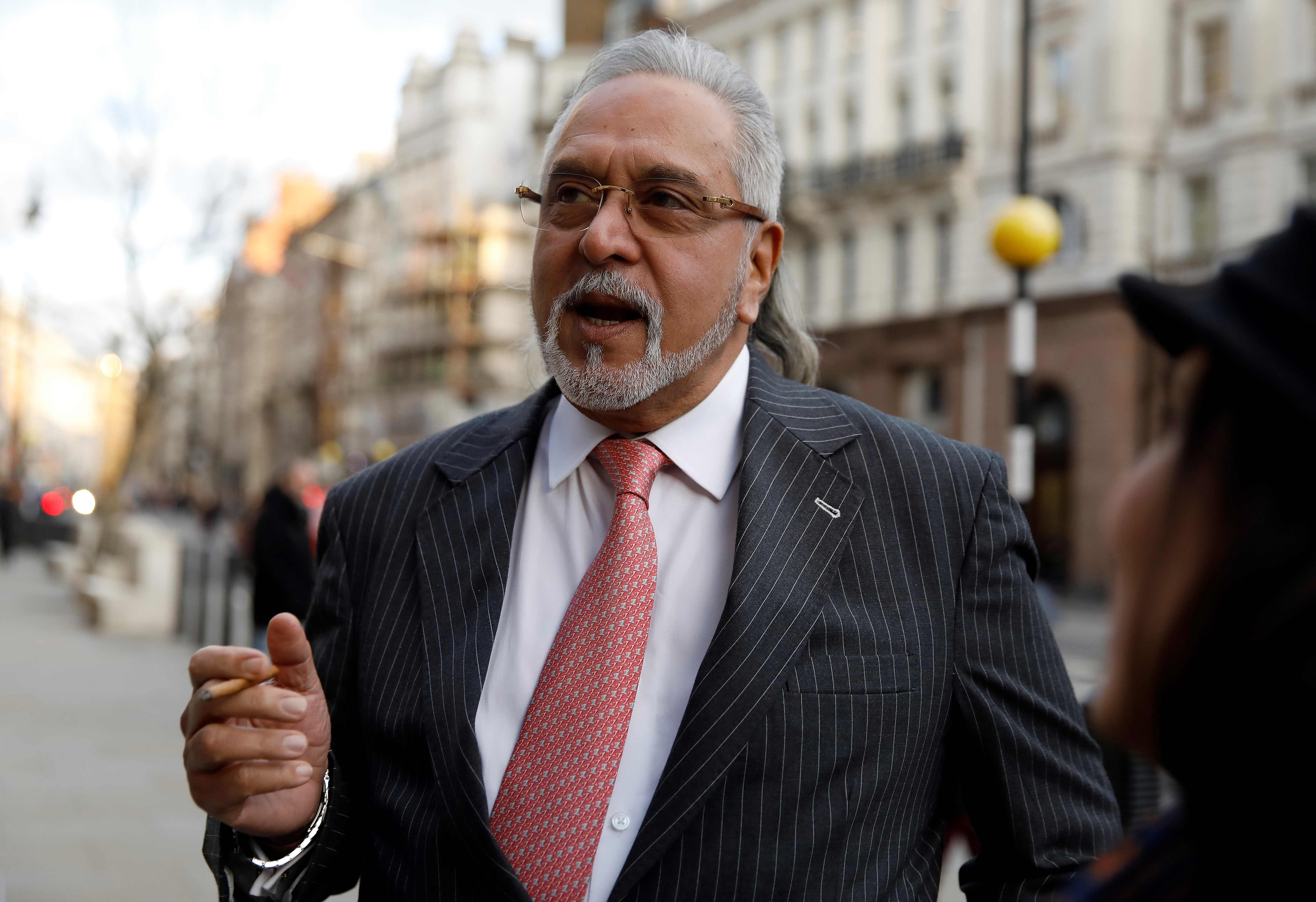 Indian tycoon Vijay Mallya leaves the Royal Courts of Justice, Britain's High Court, in central London. (AFP Photo)