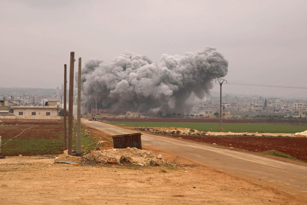 Smoke billows following a reported Syrian government air strike on the town of Atareb in the rebel-held western countryside of Syria's Aleppo province on February 13, 2020 as regime forces push on with their offensive in the country's northwest. (Photo by AFP)