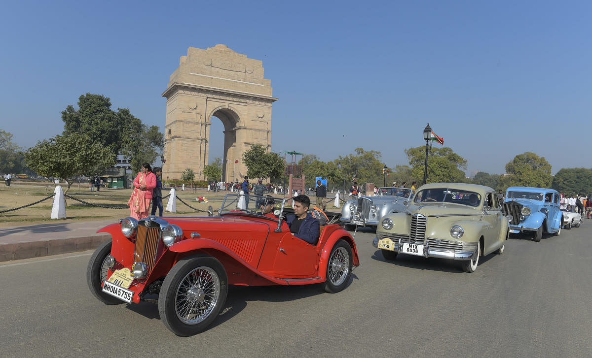 Participants drive the 1932 MG J2 followed by other vintage cars during the 21 Gun Salute International Vintage Car Rally at India Gate, New Delhi, Saturday, Feb 15, 2020. (PTI Photo)