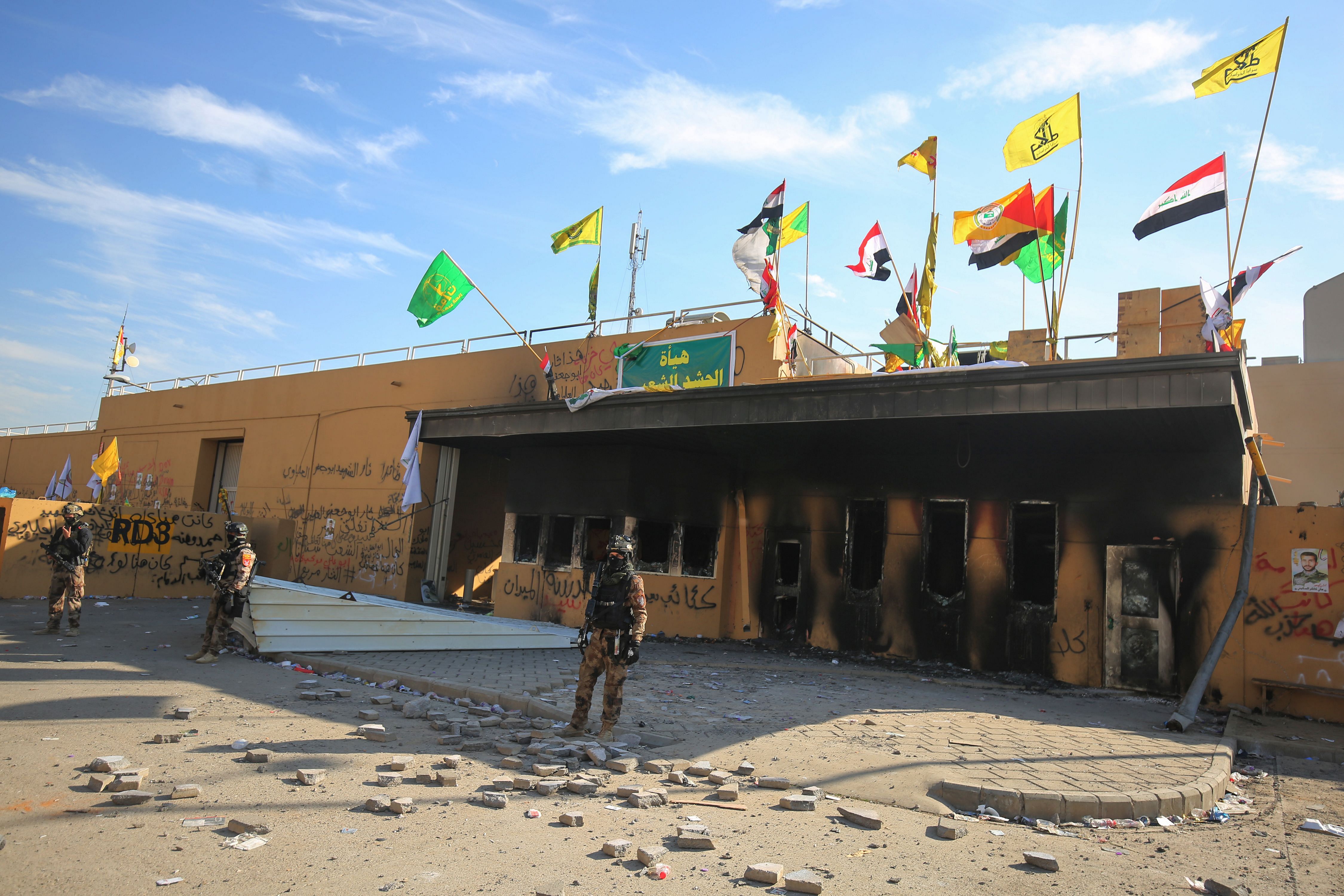 Iraqi security forces stand guard in front the US embassy in the capital Baghdad, on January 1, 2020. (Credit: AFP Photo)