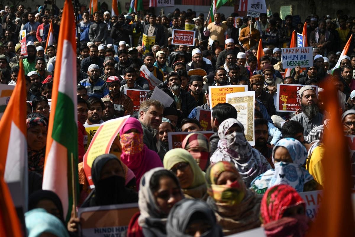 Protesters from Shaheen Bagh hold placards as they take part in a demonstration against India's new citizenship law at Jantar Mantar, in New Delhi on January, 29, 2020. (Photo by AFP)