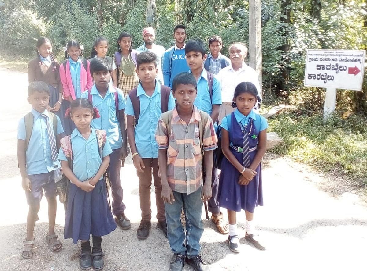 Without bus service, students are forced to walk to school at Karabailu.