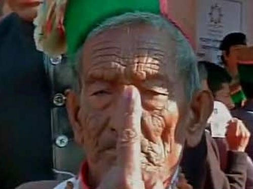 India's first voter Shyam Saran Negi today cast his vote at a polling booth at his native place here. 97-year old Negi reached the polling booth at 6.55 AM accompanied by his wife Hira Mani (92). Tv grab