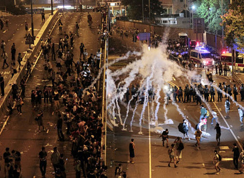 Riot police fire tear gas on student protesters occupying streets surrounding the government headquarters in Hong Kong, early Monday, Sept. 29, 2014. Pro-democracy protests in Hong Kong have handed the Chinese leadership a major political dilemma. AP file photo