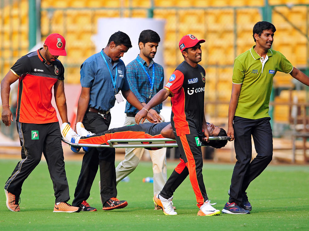 Another blow: RCB young gun Sarfaraz Khan being carried away on a stretcher after sustaining an injury. DH photo