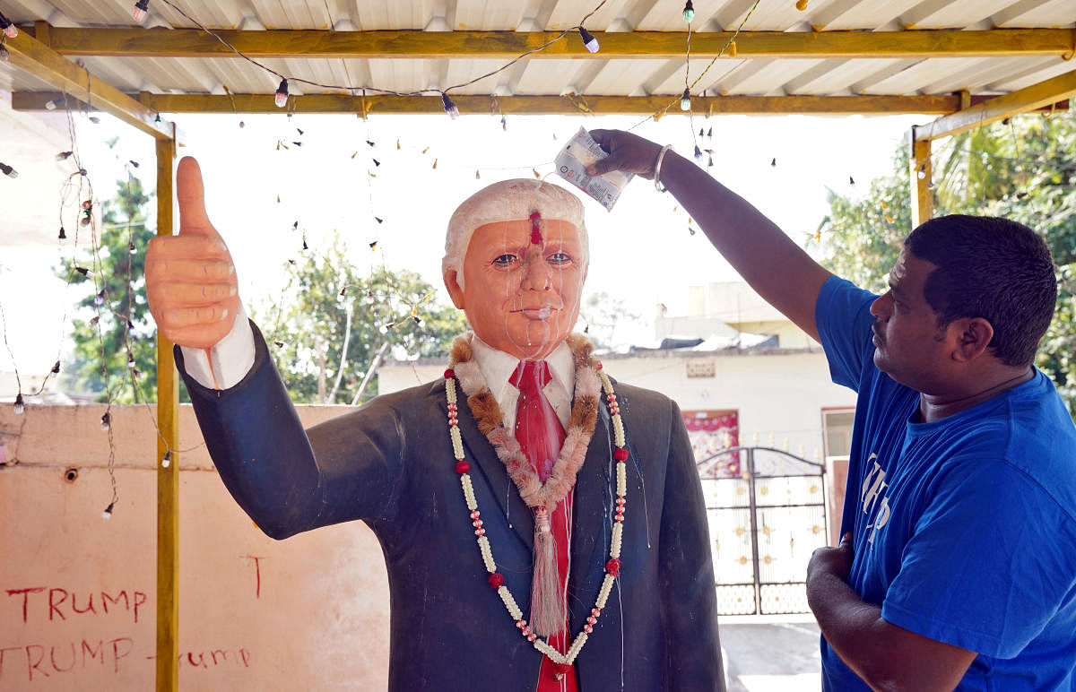 Bussa Krishna, a fan of U.S. President Donald Trump, offers prayers to a statue of Trump. (Reuters file photo)