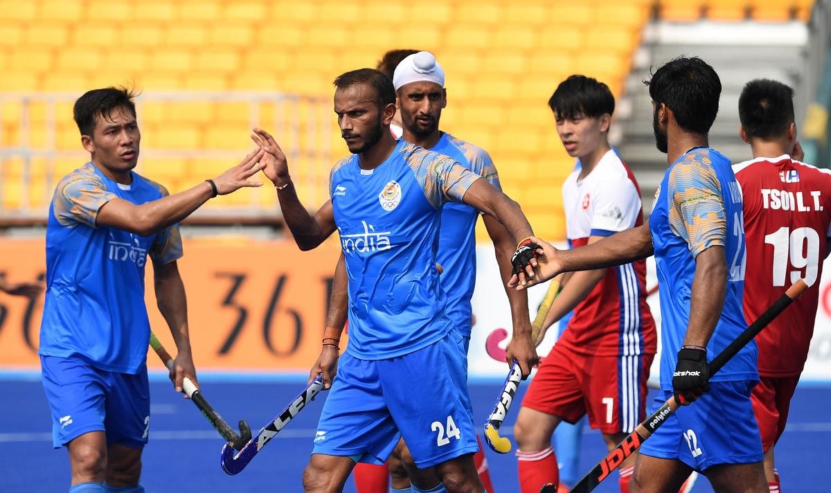 India's SV Sunil (second from left) celebrates with team-mates after scoring against Hong Kong in their men's hockey pool A match on Wednesday. AFP