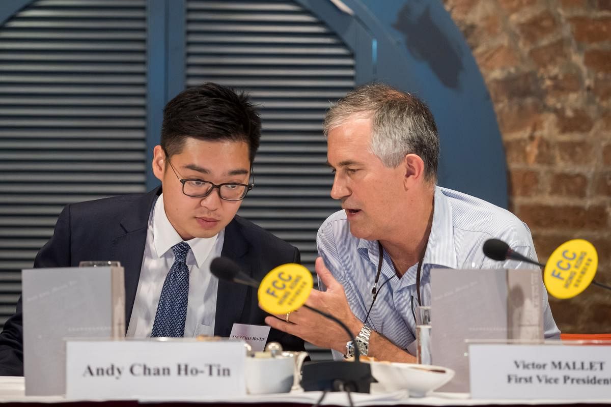 Financial Times journalist and vice president of the Foreign Correspondents' Club Victor Mallet (right) speaks with Hong Kong National Party founder Andy Chan during a luncheon at the FCC in Hong Kong on August 14, 2018. AFP