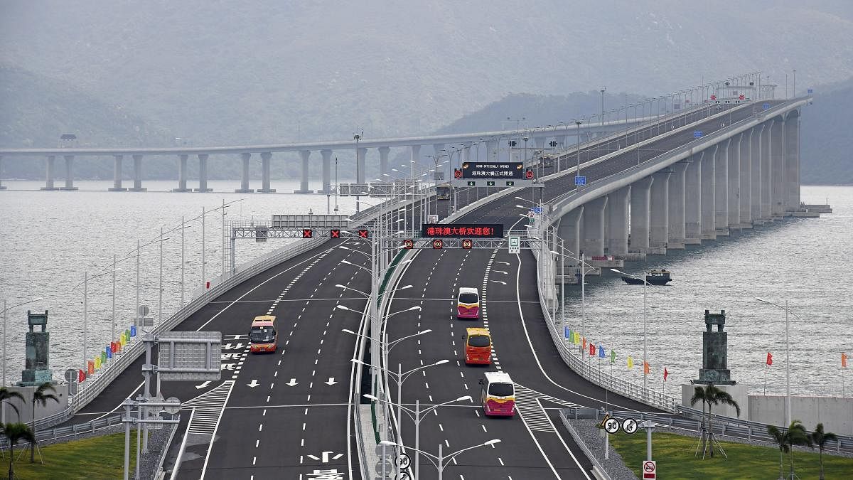 Zhuhai : In this photo released by Xinhua News Agency, buses drive on the China-Zhuhai-Macau-Hong Kong Bridge during the first day operation of the world's longest cross-sea project, which has a total length of 55 kilometers (34 miles), in Zhuhai in south