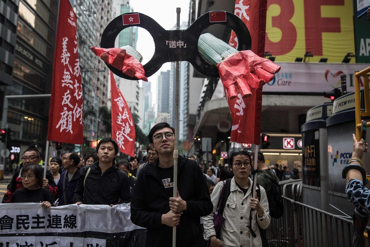 Protesters march along a street during a rally in Hong Kong on March 31, 2019 to protest against the government's plans to approve extraditions with mainland China, Taiwan and Macau. AFP File photo
