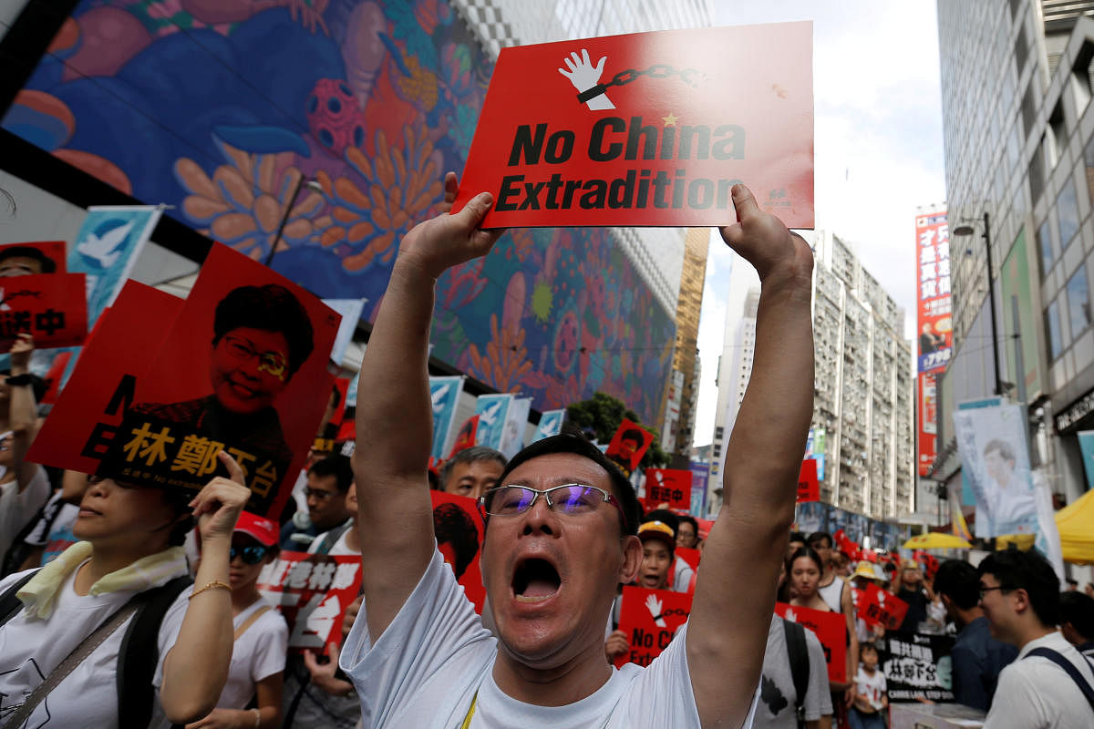 A demonstrator holds up a sign during a protest to demand authorities scrap a proposed extradition bill with China, in Hong Kong, China June 9, 2019. (Reuters Photo)