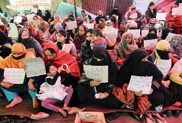 Women and children hold placards during a silent protest against CAA and NRC at Shaheen Bagh in New Delhi, Tuesday, Feb. 11, 2020. (PTI Photo)