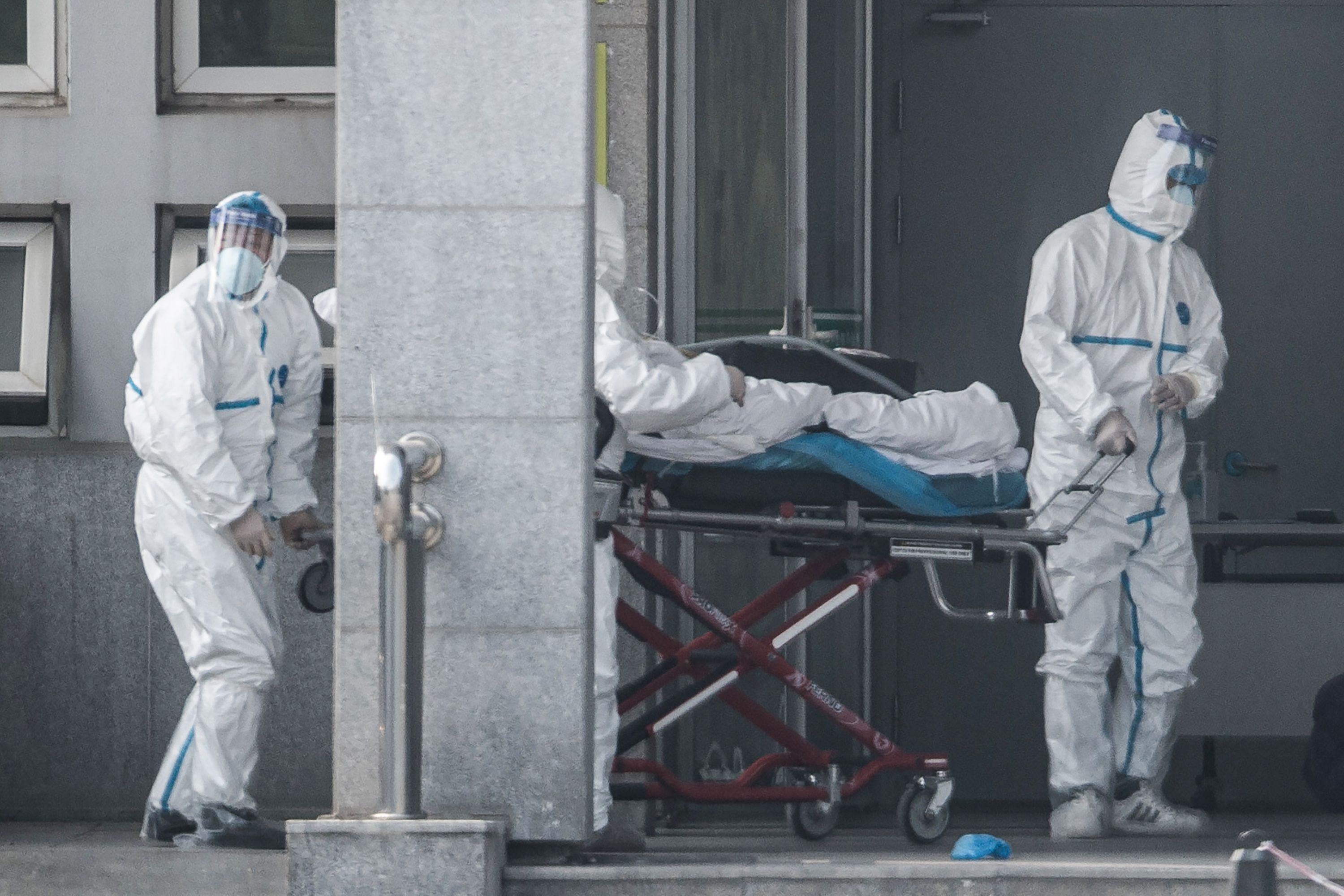 Medical staff members carry a patient into the Jinyintan hospital, where patients infected by a mysterious SARS-like virus are being treated, in Wuhan in China's central Hubei province. (AFP)