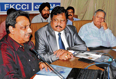 Confederation of All India Traders (CAIT) General Secretary Praveen Khandelwal speaking at a round table meeting organised by industry body FKCCI in Bangalore on Friday. FKCCI's past president R Shivakumar is also seen. DH Photo