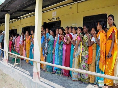 Women standing in queue to cast their votes for the Bodoland Territorial Council (BTC) elections Baganpara in Baska district on Wednesday. PTI Photo