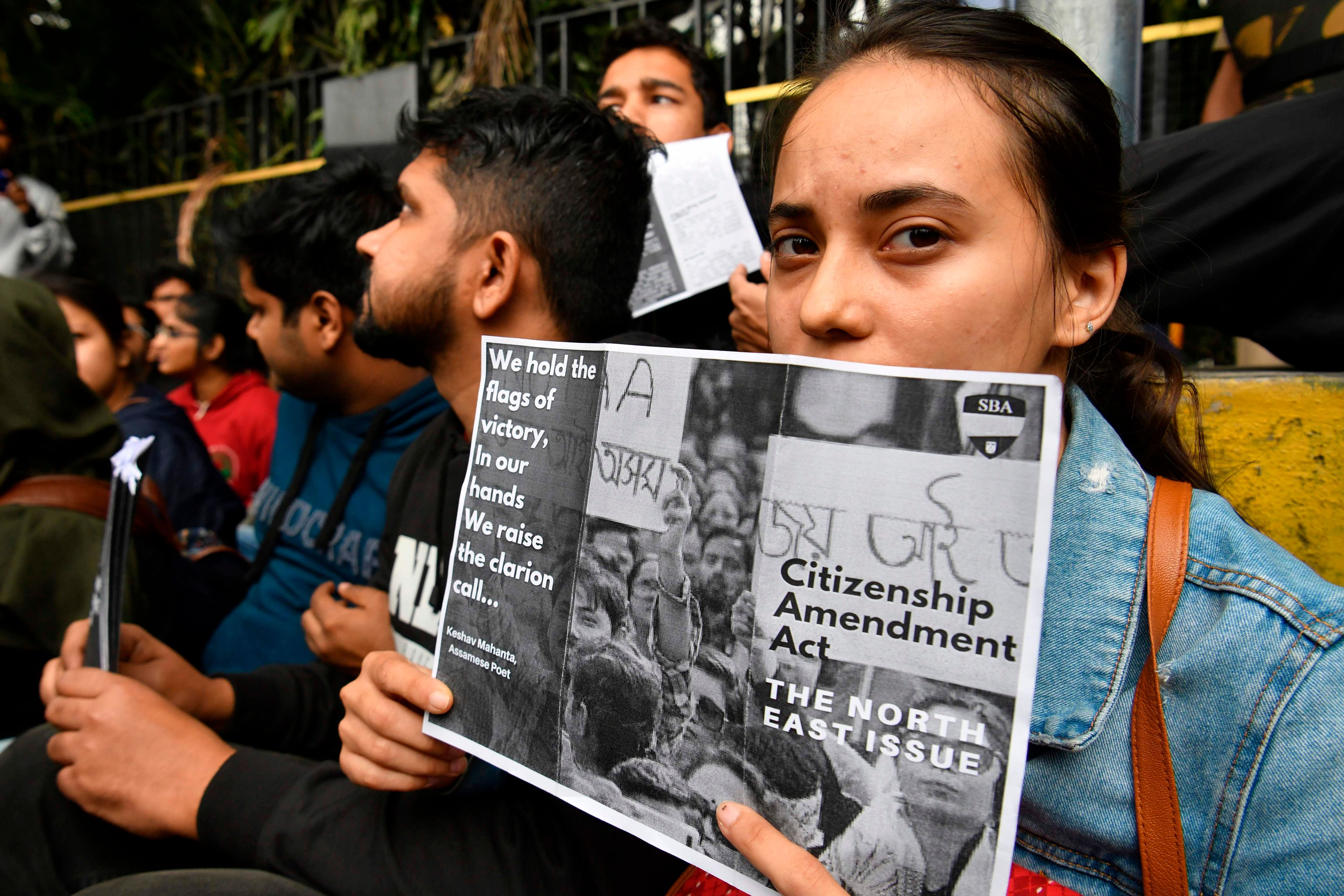 Protesters shout slogans and hold placards at the Town Hall during a demonstration held against India's new citizenship law in spite of a curfew in Bangalore on December 19, 2019. (AFP Photo)