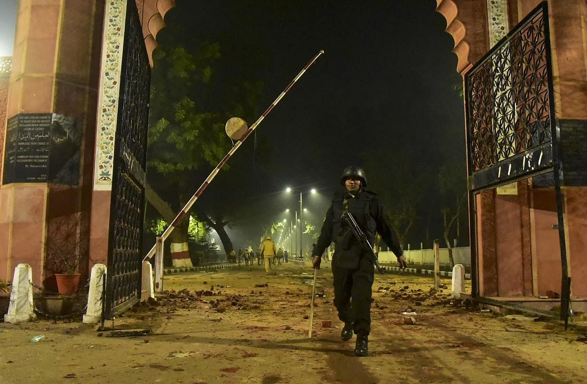  A Security personel stand guard near Aligarh Muslim University (AMU) after the violent protests against Citizenship Amendment Act, in Aligarh. PTI