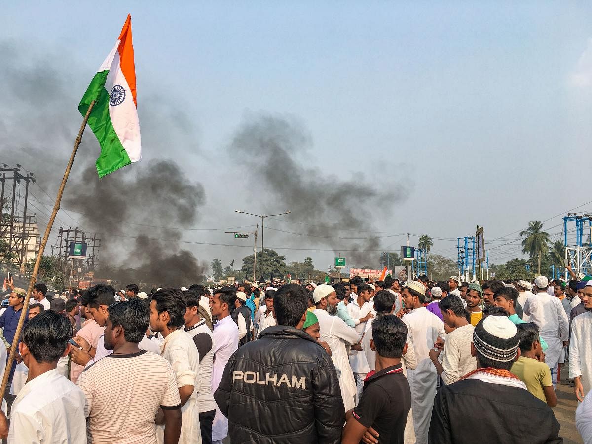 Muslim community members block the National Highway 6 during a protest against NRC and the Citizenship Amendment Bill, in West Bengal’s Uluberia district. (PTI photo)