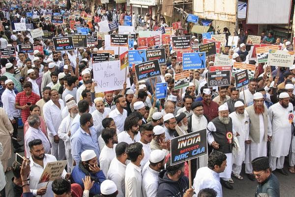 Protestors hold placards during a rally against the Citizenship Amendment Act (CAA) in Pune, Friday, Dec. 20, 2019. (PTI Photo)
