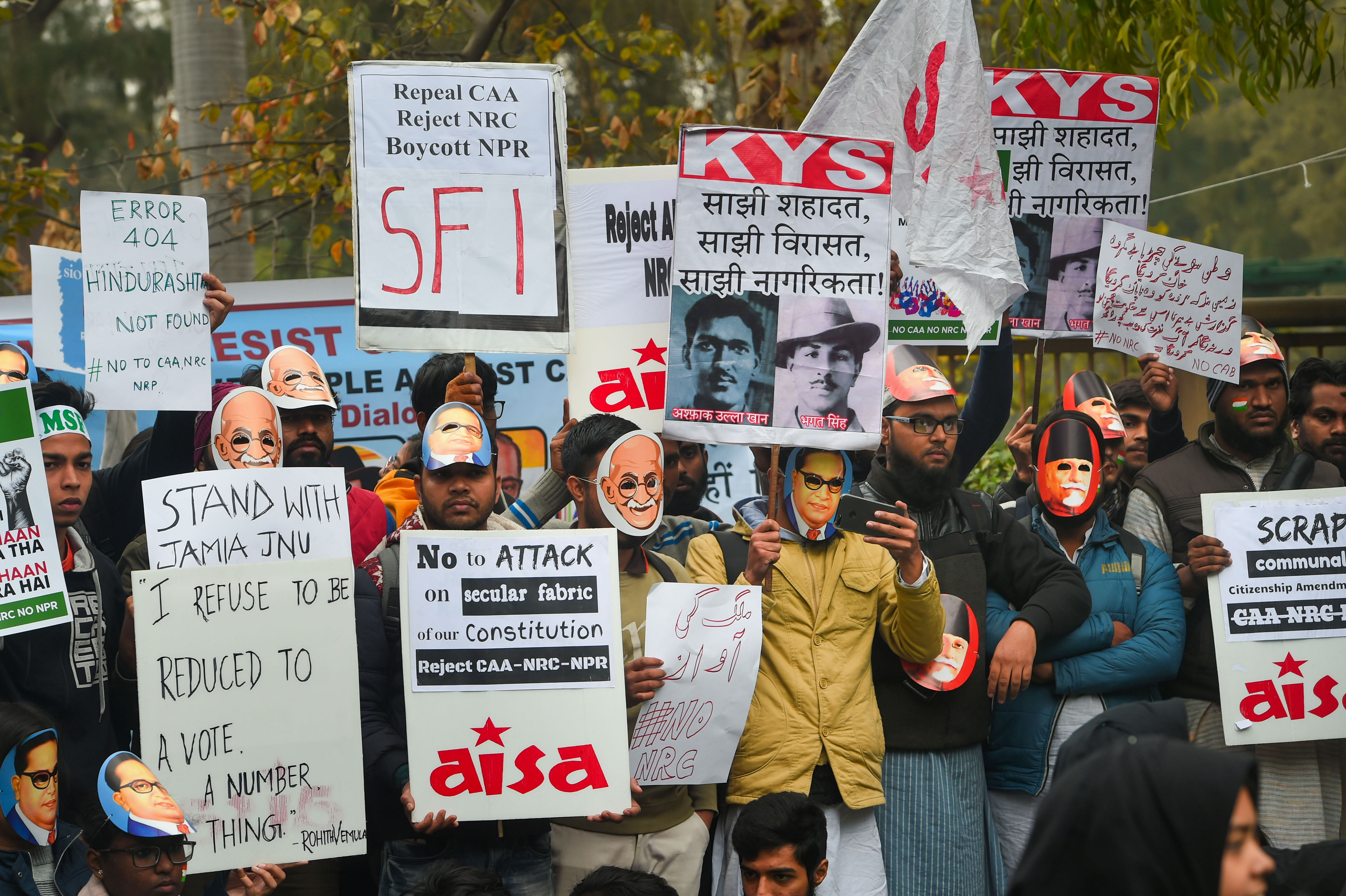 Students display posters and placards during a protest against CAA and NRC at Delhi University's North Campus. (PTI Photo)