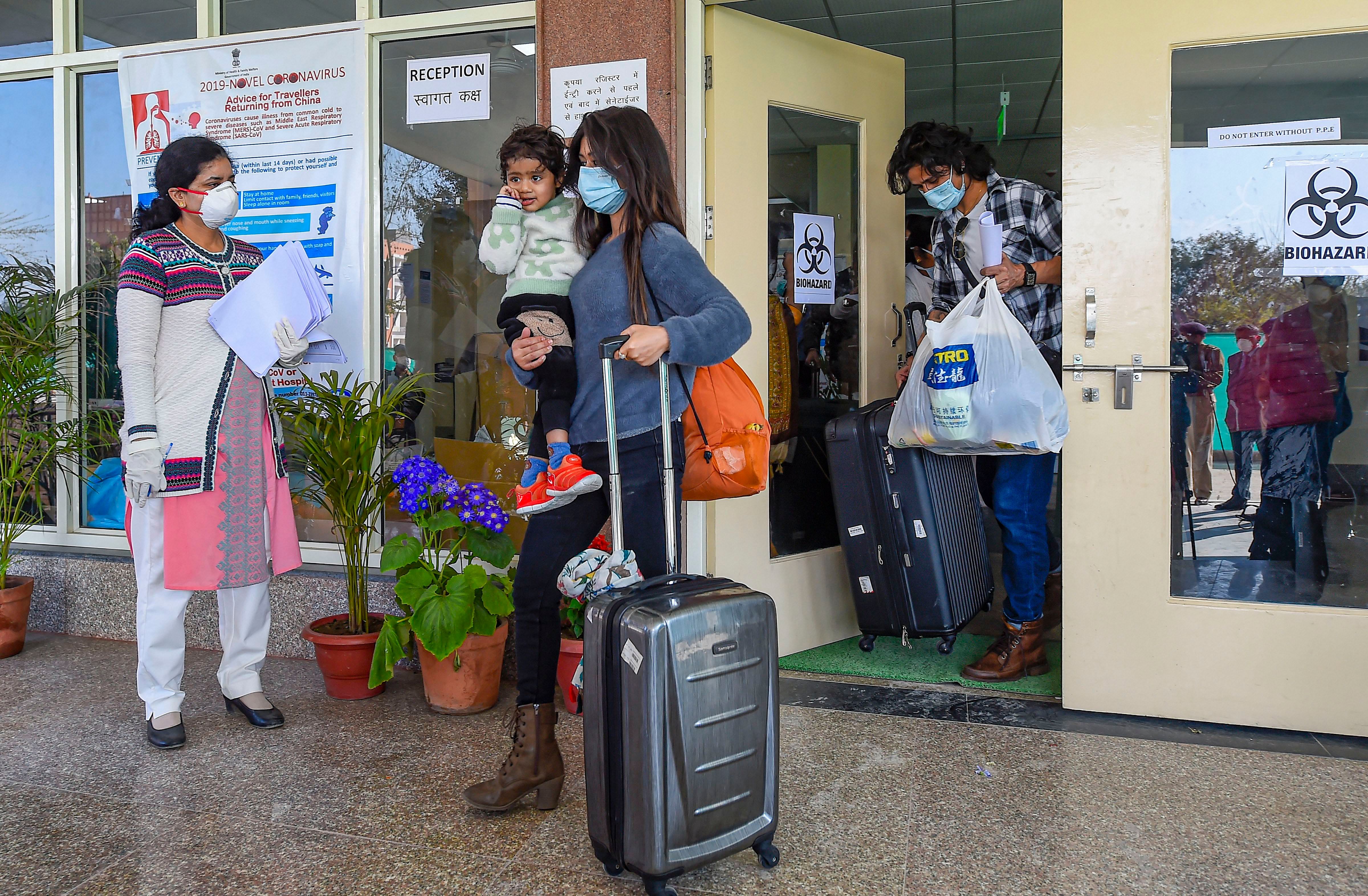 Indians who were air-lifted from Wuhan following out-break of the deadly novel cornavirus, prepare to leave following their release from the ITBP quarantine facility, at Chhawla, in New Delhi. (PTI Photo)