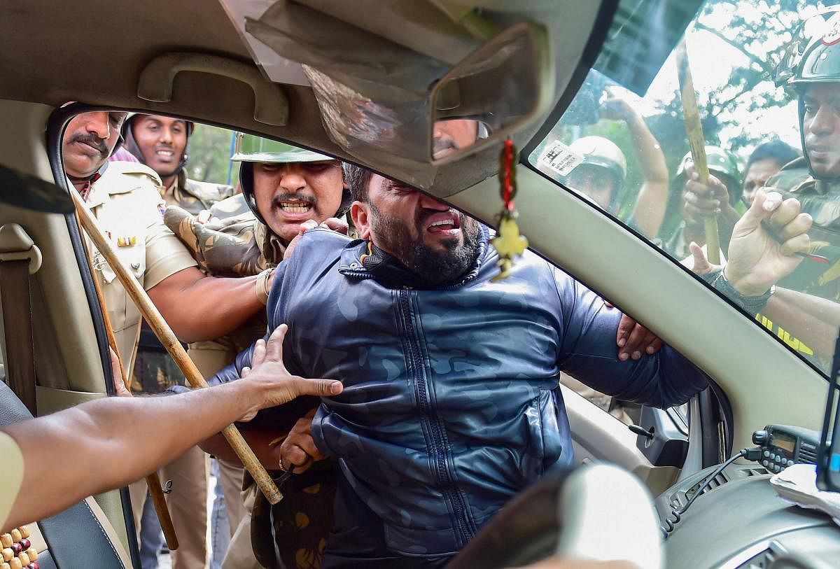 A protestor being detained by police personnel as he defies the prohibitory orders imposed in the area, during a rally against the amended Citizenship Act, in Bengaluru. PTI