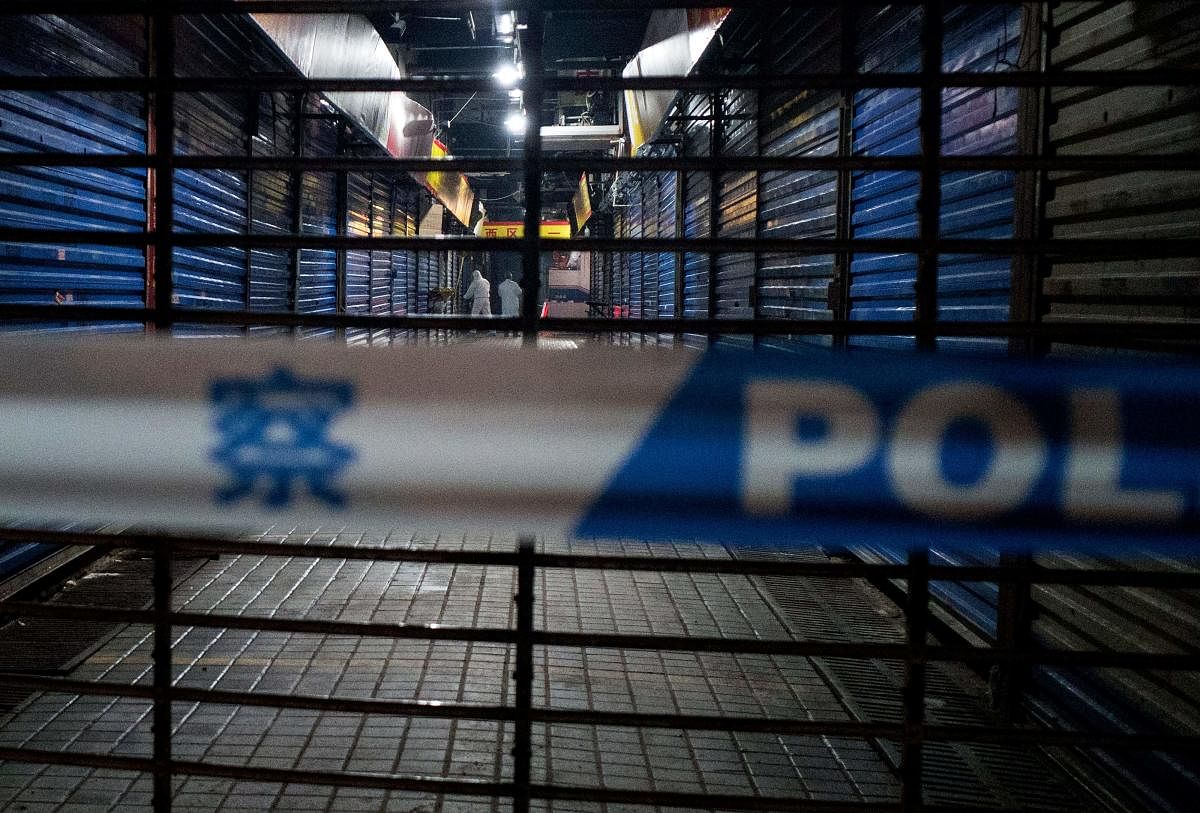 Members of staff of the Wuhan Hygiene Emergency Response Team conduct searches on the closed Huanan Seafood Wholesale Market in the city of Wuhan, in the Hubei Province of China. AFP