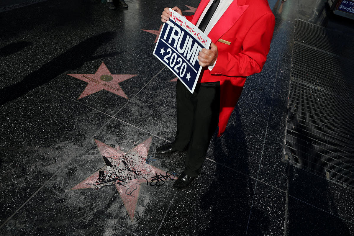Greg Donovan, 58, stands on President Donald Trump's vandalized star on the Hollywood Walk of Fame in Hollywood, Los Angeles, California, U.S. July 25, 2018. REUTERS/Lucy Nicholson