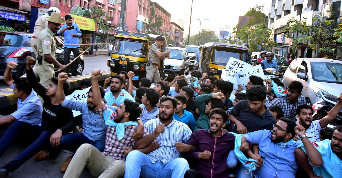 Police use mild force on the activists of Campus Front of India who resorted to sudden protest by blocking road at Balmatta Junction in Mangaluru on Monday. DH Photo