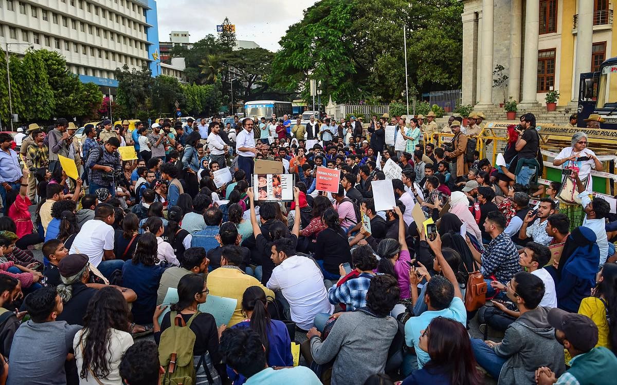 Protestors hold placards and raise slogans protesting against the amended Citizenship Act and police atrocities on students demonstrating over CAA, in Bengaluru, Monday, Dec. 16, 2019. (PTI Photo)