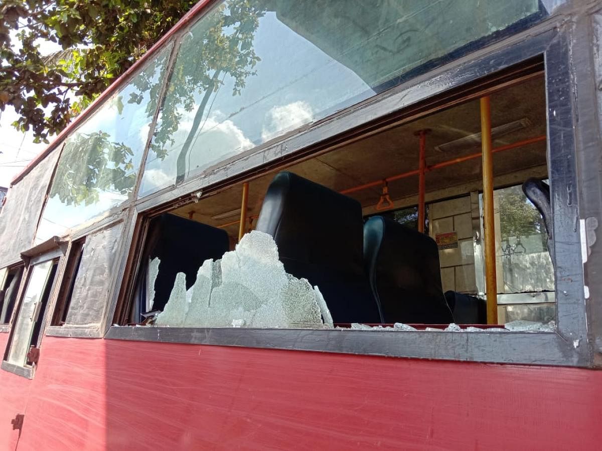 A NWKRTC bus damaged in the stone pelting after a few protesters went berserk in Belagavi on Tuesday. DH PHOTO